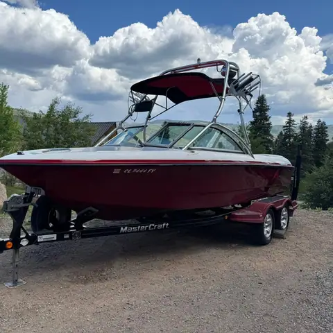 Red MasterCraft wake boat on its trailer after a full exterior detail